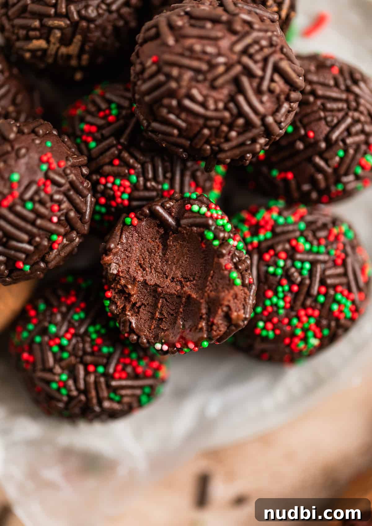 Amaretto Truffles Recipe with 5 Ingredients — Simple Chocolate Bonbons 3 Chocolate, red and green sprinkle covered amaretto truffles arranged on dish.