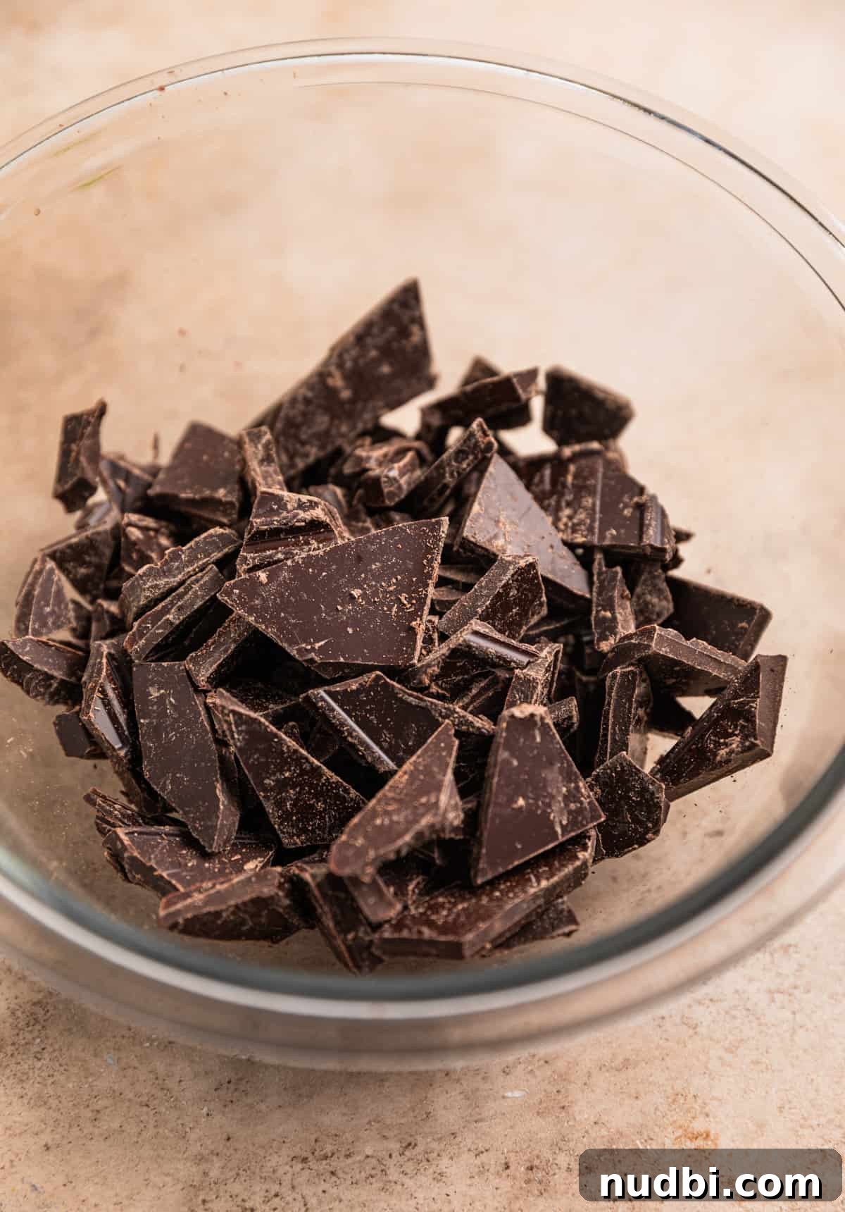 Amaretto Truffles Recipe with 5 Ingredients — Simple Chocolate Bonbons 4 Chopped dark chocolate in glass bowl.