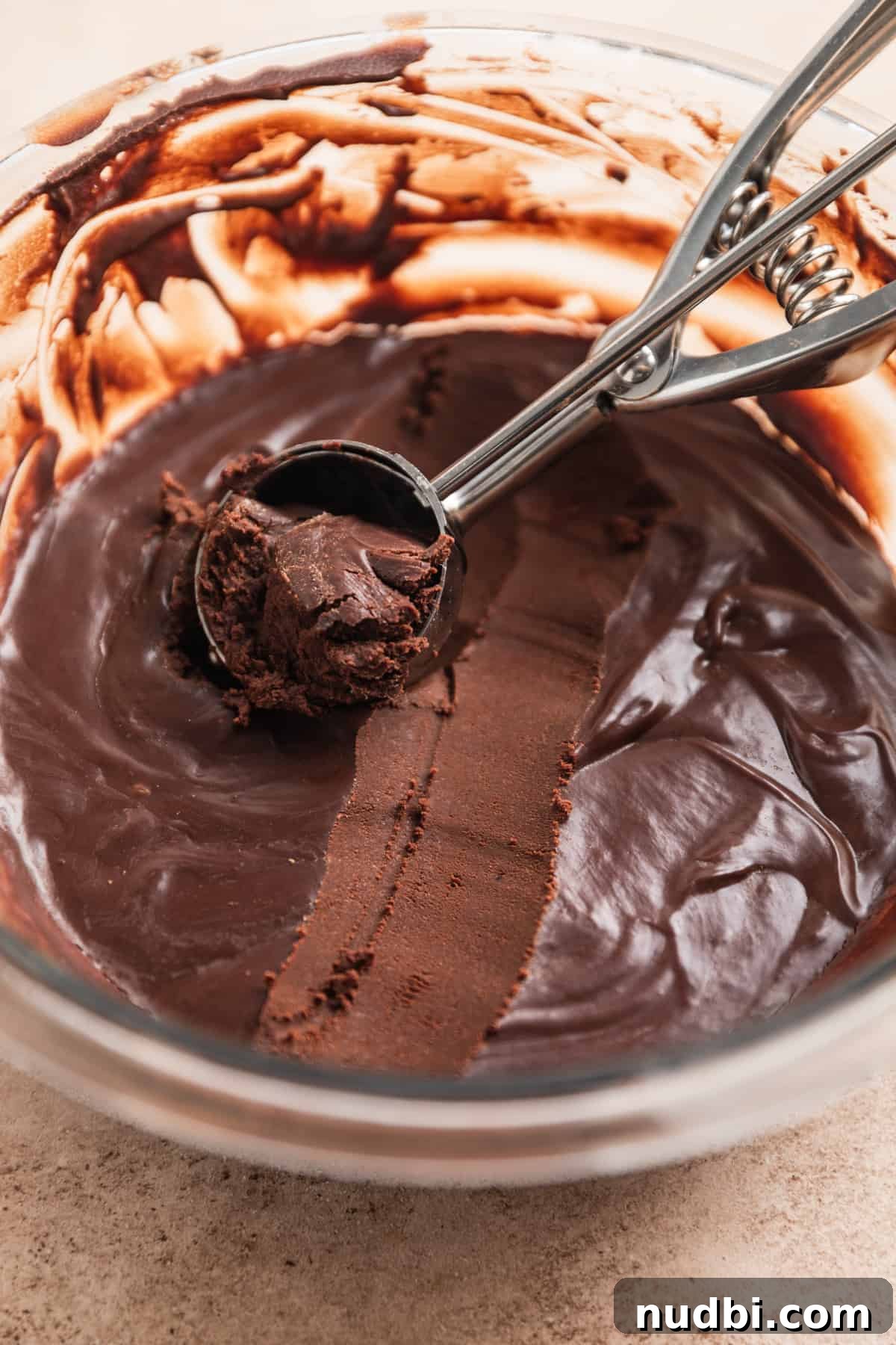 Amaretto Truffles Recipe with 5 Ingredients — Simple Chocolate Bonbons 8 Cookie scoop with chocolate truffle mixture scooped.