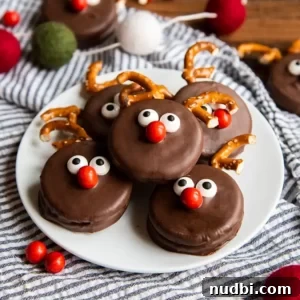 White plate with chocolate covered Oreos with reindeer nose and pretzel antlers.