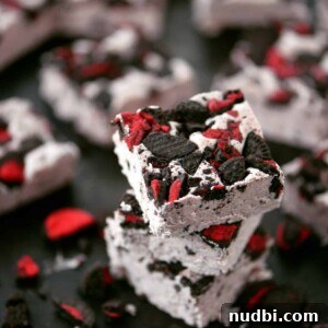 White chocolate fudge with red icing filled Oreos.