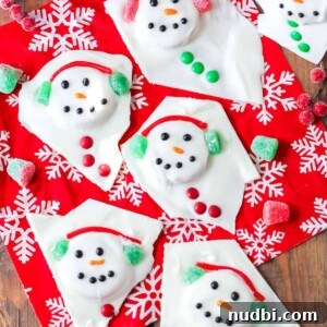 White chocolate bark made to look like a melted snowman on Christmas towel.