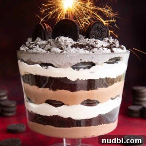 Trifle dish with layers of Oreos, cream and chocolate pudding.