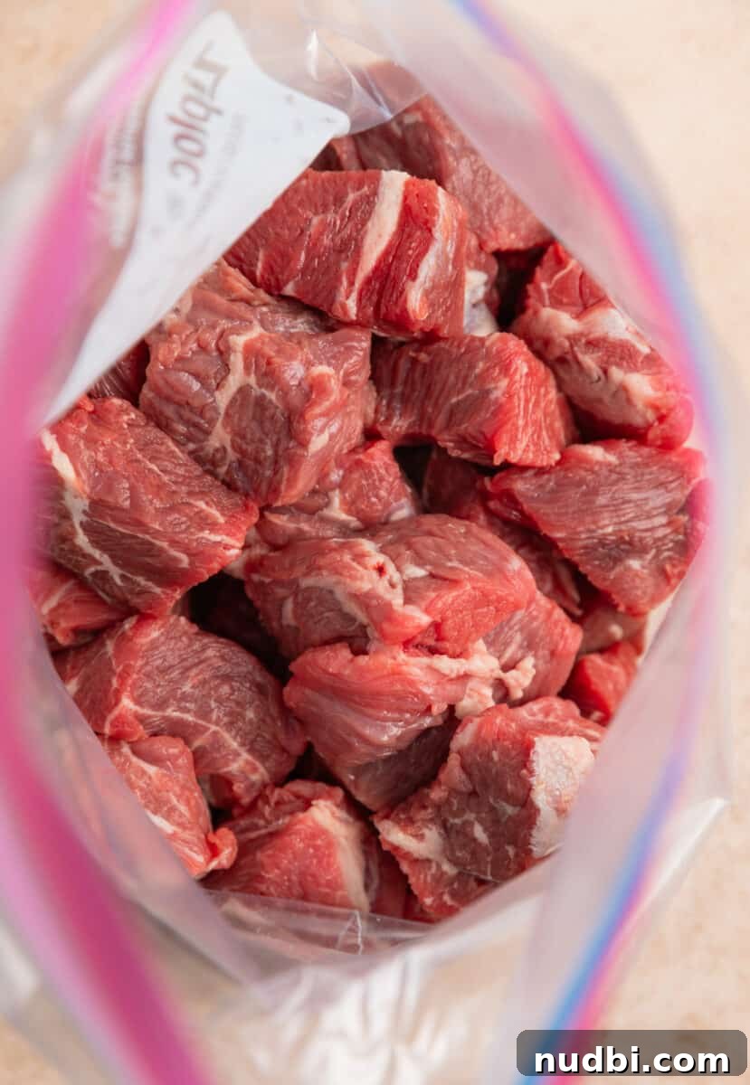Slow Cooker Beef and Mushroom Stew Recipe for Tender Comfort Food 5 Cubed beef in plastic bag.