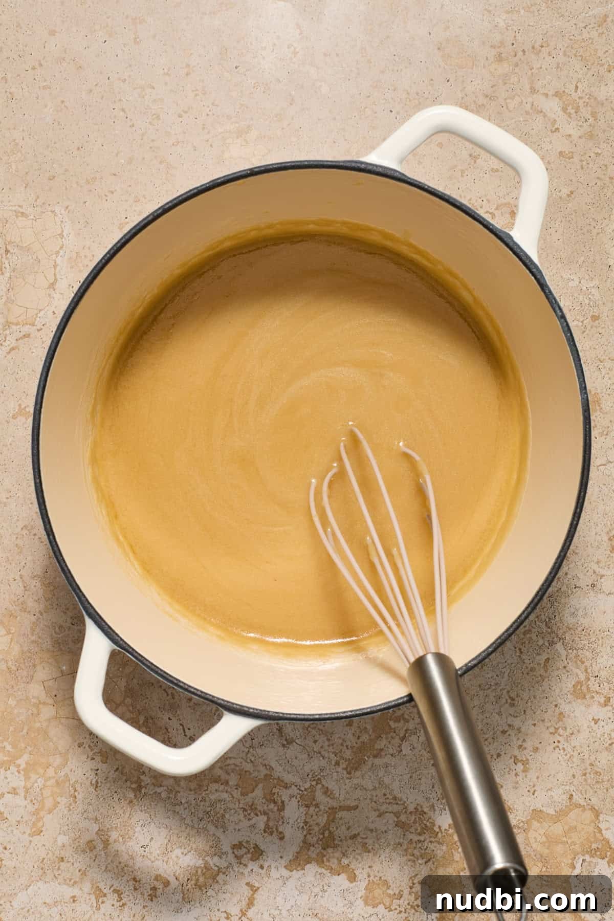 Juicy Slow Cooker Turkey Breast Recipe 11 Turkey gravy made in pot with whisk.