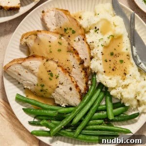 Juicy Slow Cooker Turkey Breast Recipe 18 Slices of turkey breast on plate with mashed potatoes and green beans.