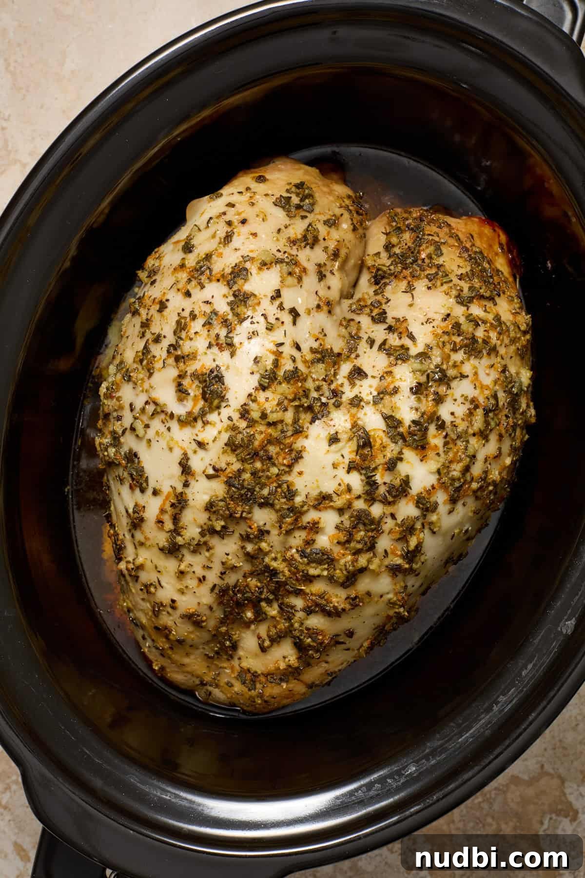Juicy Slow Cooker Turkey Breast Recipe 9 Cooked slow cooker turkey breast in pot.