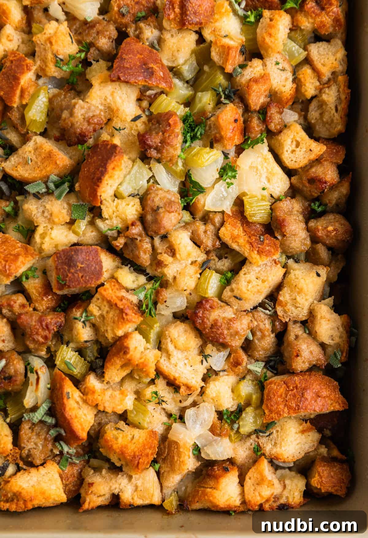 Turkey Sausage Stuffing Recipe for Thanksgiving and Holiday Meals 2 Pan with turkey sausage stuffing baked and topped with freshly chopped parsley and thyme.