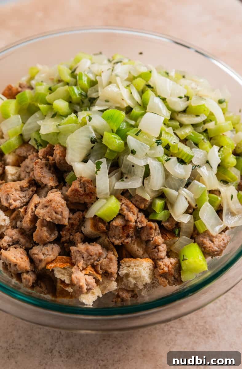 Turkey Sausage Stuffing Recipe for Thanksgiving and Holiday Meals 11 Celery and onion mixture added to turkey sausage stuffing ingredients in glass mixing bowl.