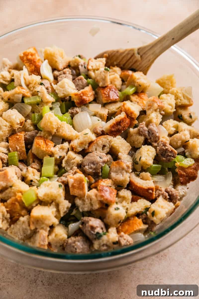 Turkey Sausage Stuffing Recipe for Thanksgiving and Holiday Meals 13 Turkey sausage stuffing mixture tossed together before baking in mixing bowl.