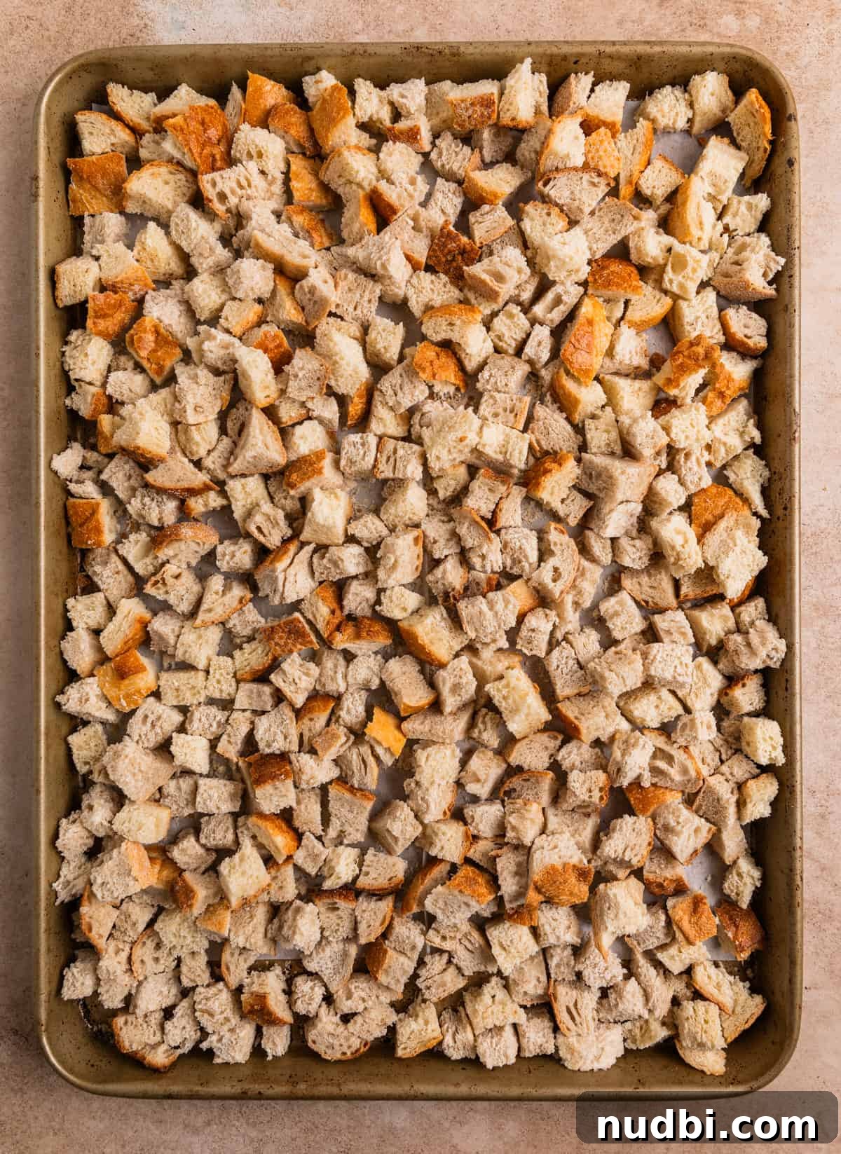 Turkey Sausage Stuffing Recipe for Thanksgiving and Holiday Meals 5 Cubed sourdough bread on baking sheet.