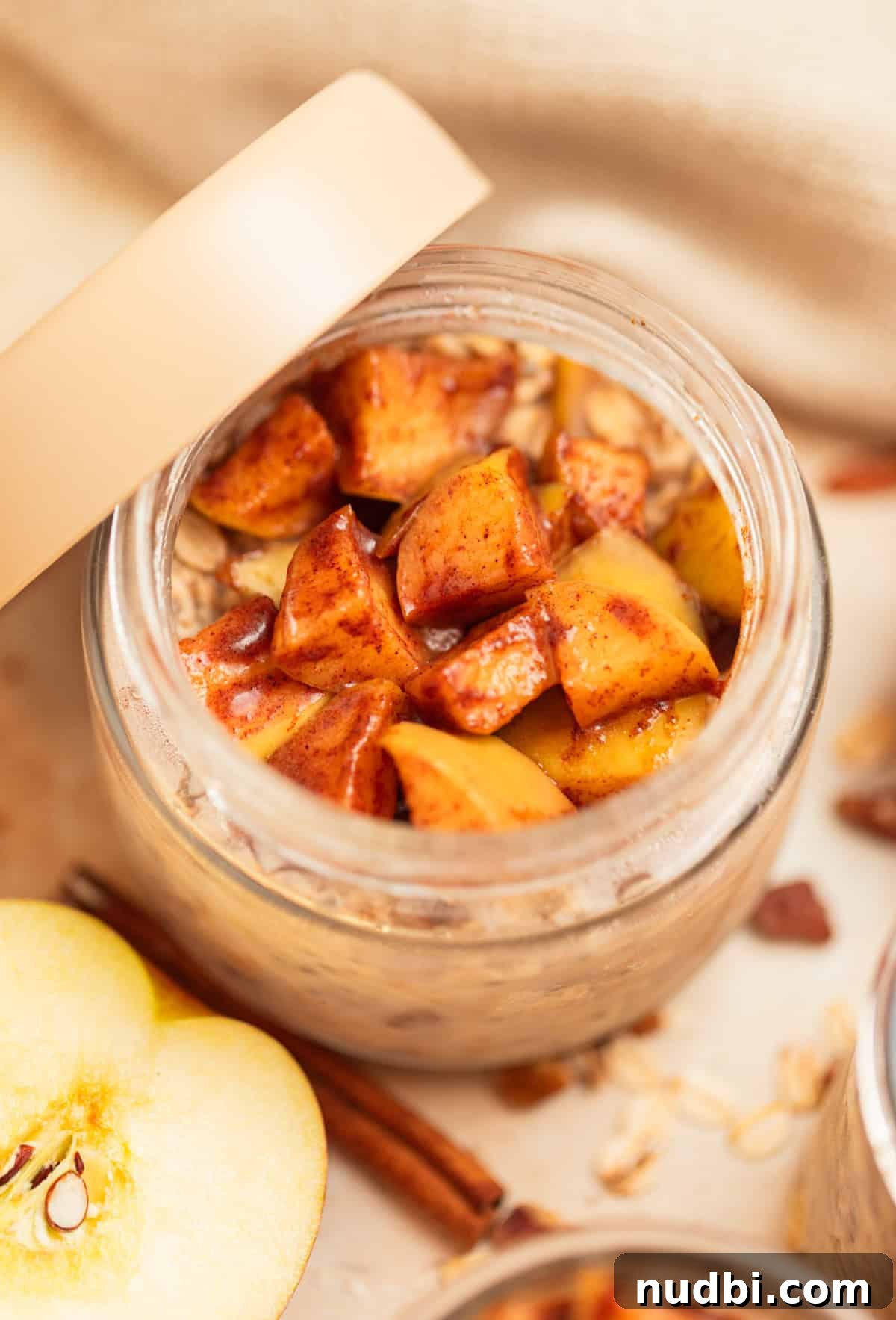 Apple Cinnamon Overnight Oats Recipe for Quick Breakfast 11 Jar with overnight apple cinnamon oatmeal with lid propped up against the jar.