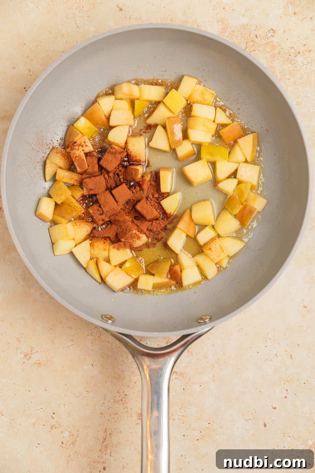 Apple Cinnamon Overnight Oats Recipe for Quick Breakfast 5 Softened apples in skillet with cinnamon, water and maple syrup.