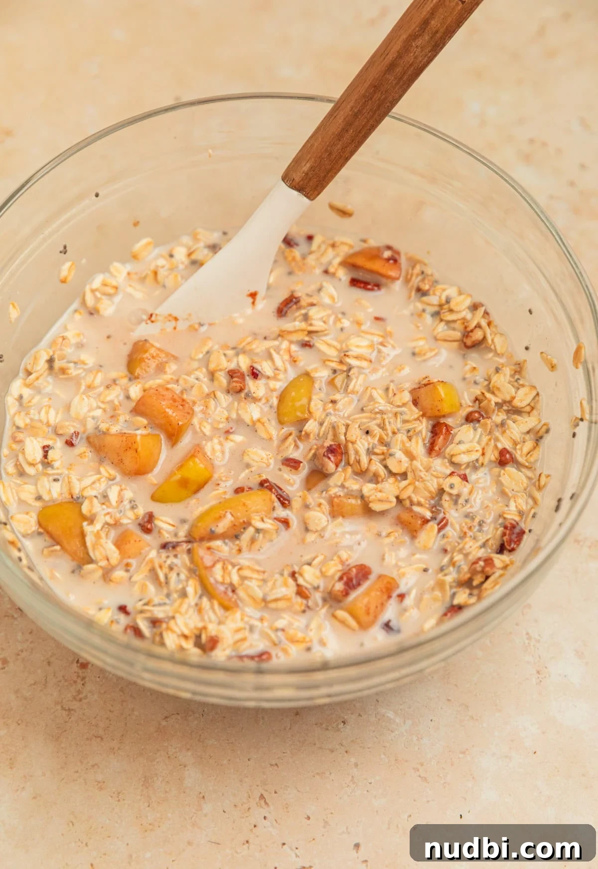 Apple Cinnamon Overnight Oats Recipe for Quick Breakfast 9 Apple overnight oatmeal mixture in bowl with spoon.