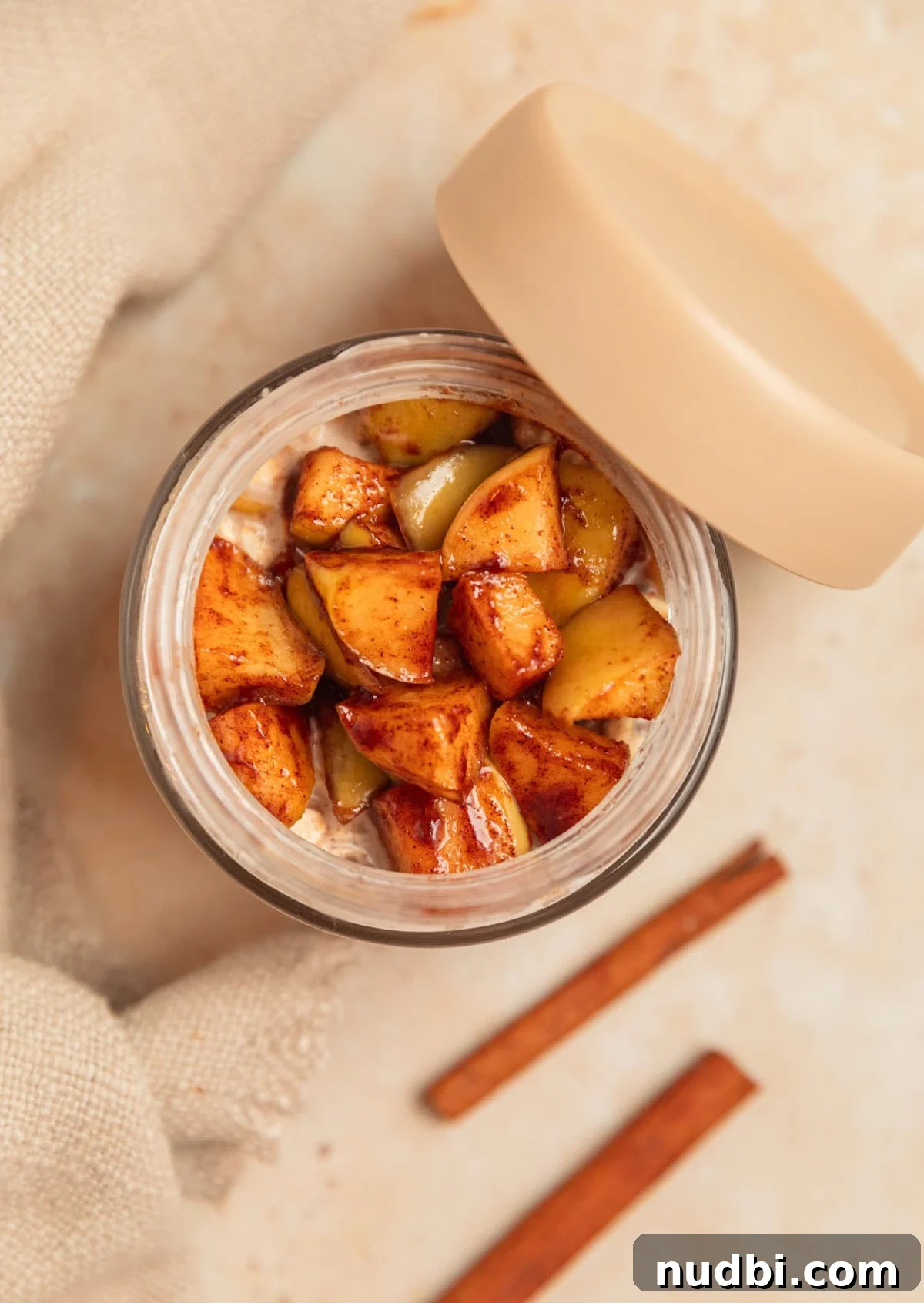 Apple Cinnamon Overnight Oats Recipe for Quick Breakfast 10 Jar with overnight oats topped with apples.