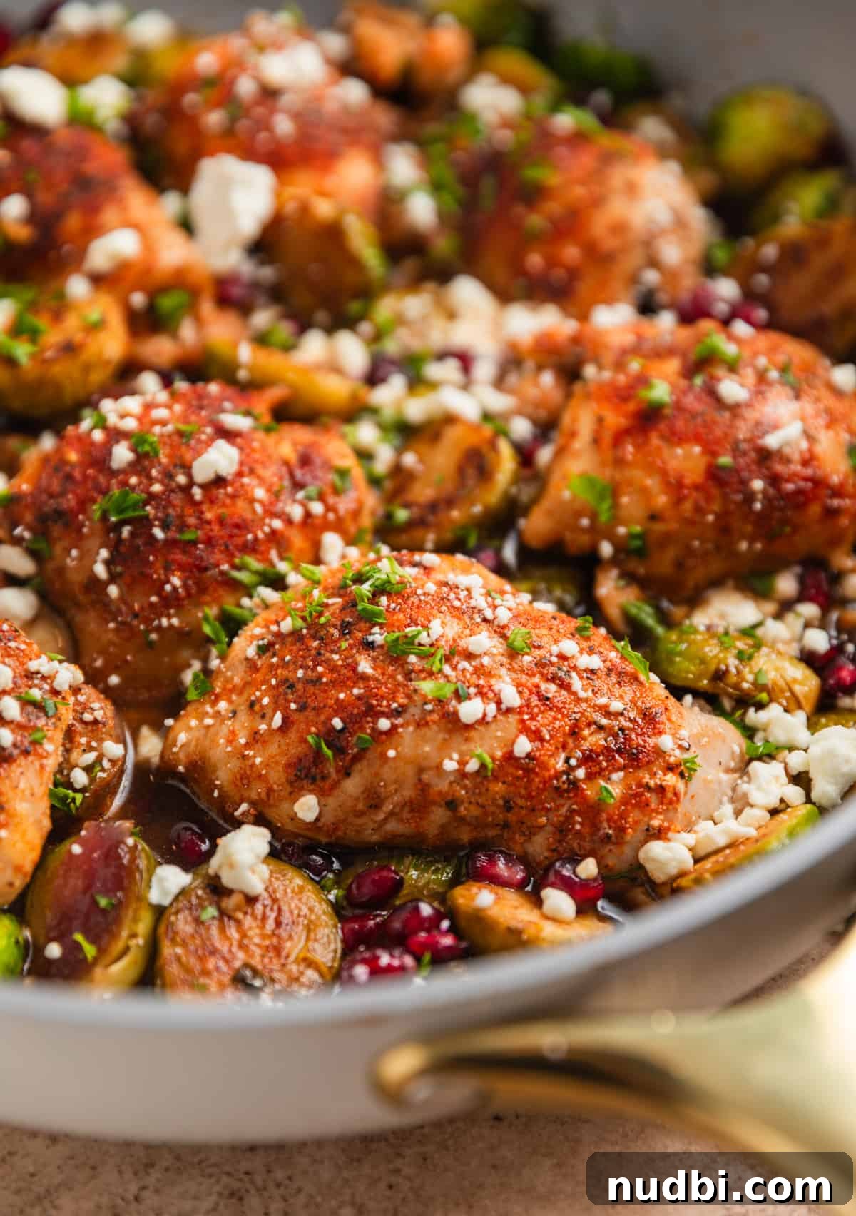 Sheet Pan Chicken Thighs with Roasted Brussels Sprouts 2 Balsamic dijon chicken thighs in skillet with brussel sprouts, goat cheese, pomegranate arils etc.