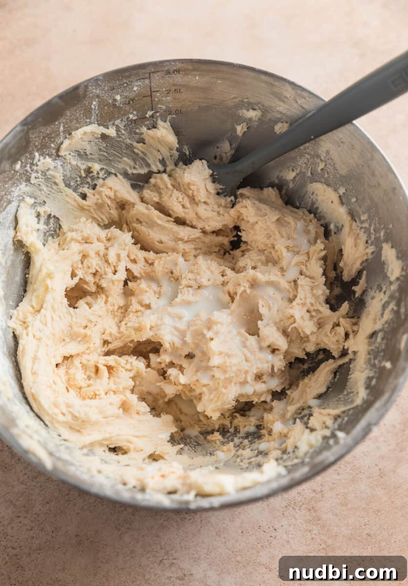 Chewy Ginger Cream Cookie Recipe for Perfect Holiday Baking 12 Buttercream frosting in mixing bowl with cream added.