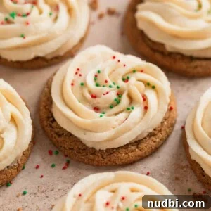 Chewy Ginger Cream Cookie Recipe for Perfect Holiday Baking 15 Ginger cookies with buttercream frosting and red and green sprinkles.