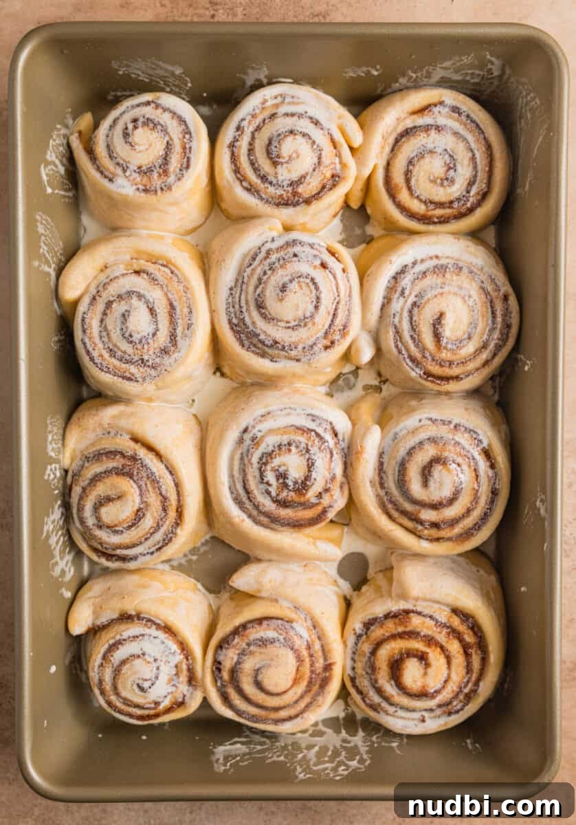 Fluffy Buttermilk Cinnamon Rolls from Scratch 16 Cinnamon rolls with heavy cream brushed over top before baking.