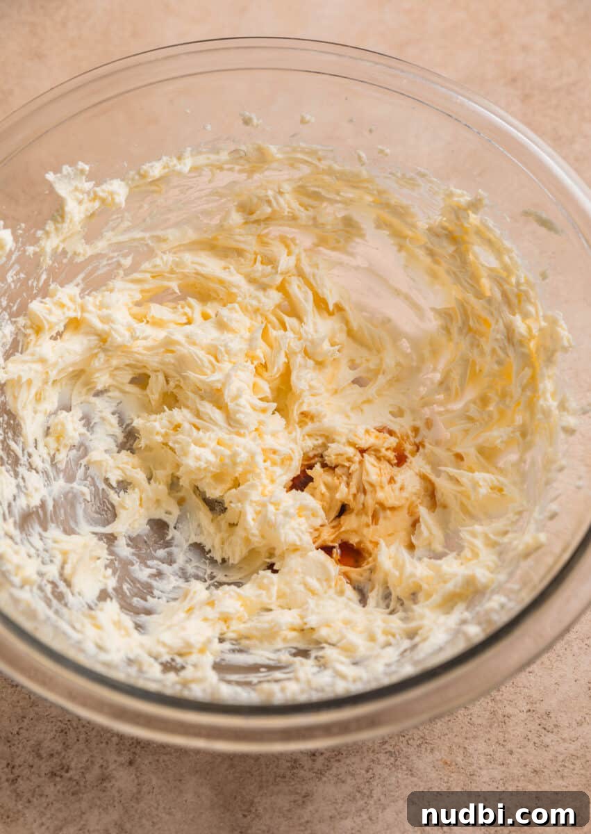 Fluffy Buttermilk Cinnamon Rolls from Scratch 18 Cream cheese and butter creamed in mixing bowl with vanilla added.