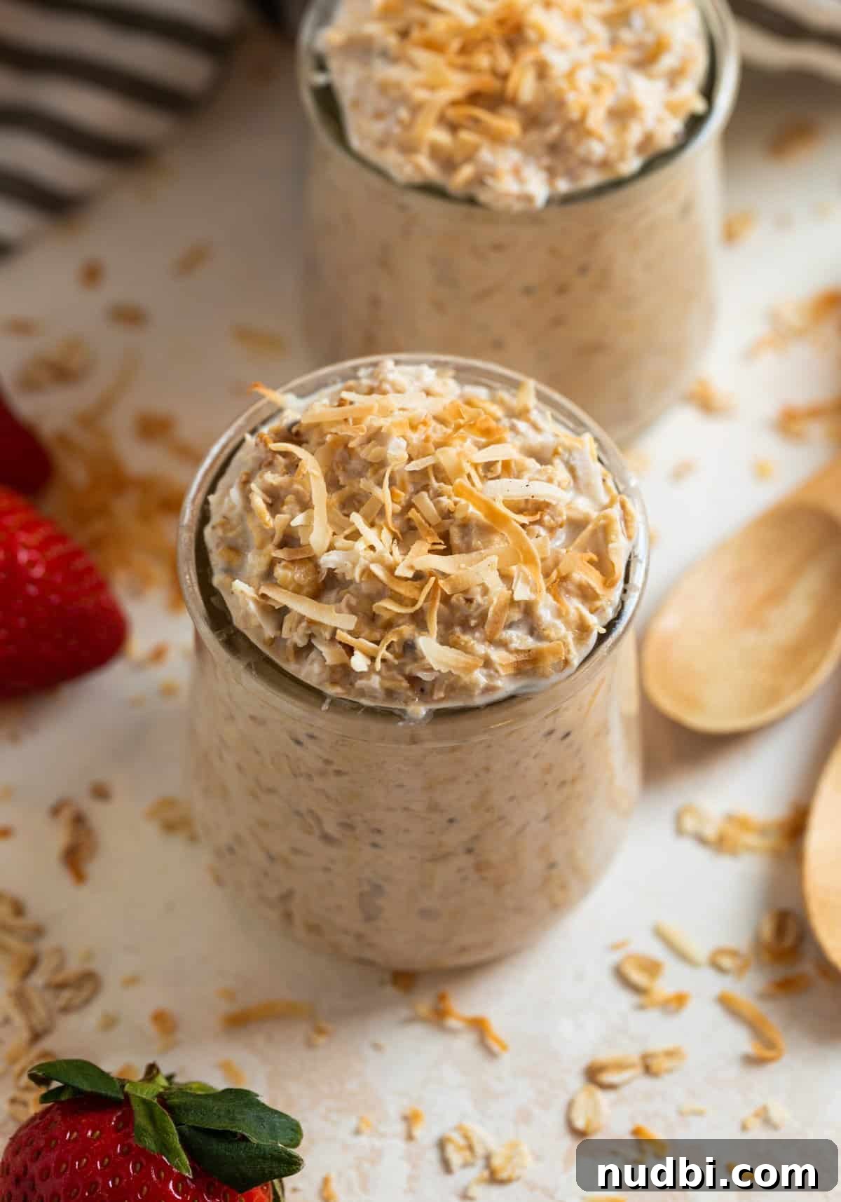 Coconut Cream Pie Overnight Oats Recipe for Creamy Breakfast 2 Jars with coconut overnight oats topped with toasted coconut.
