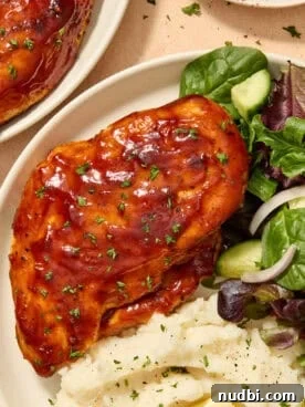 Air fryer barbecue chicken breast on plate with sides.