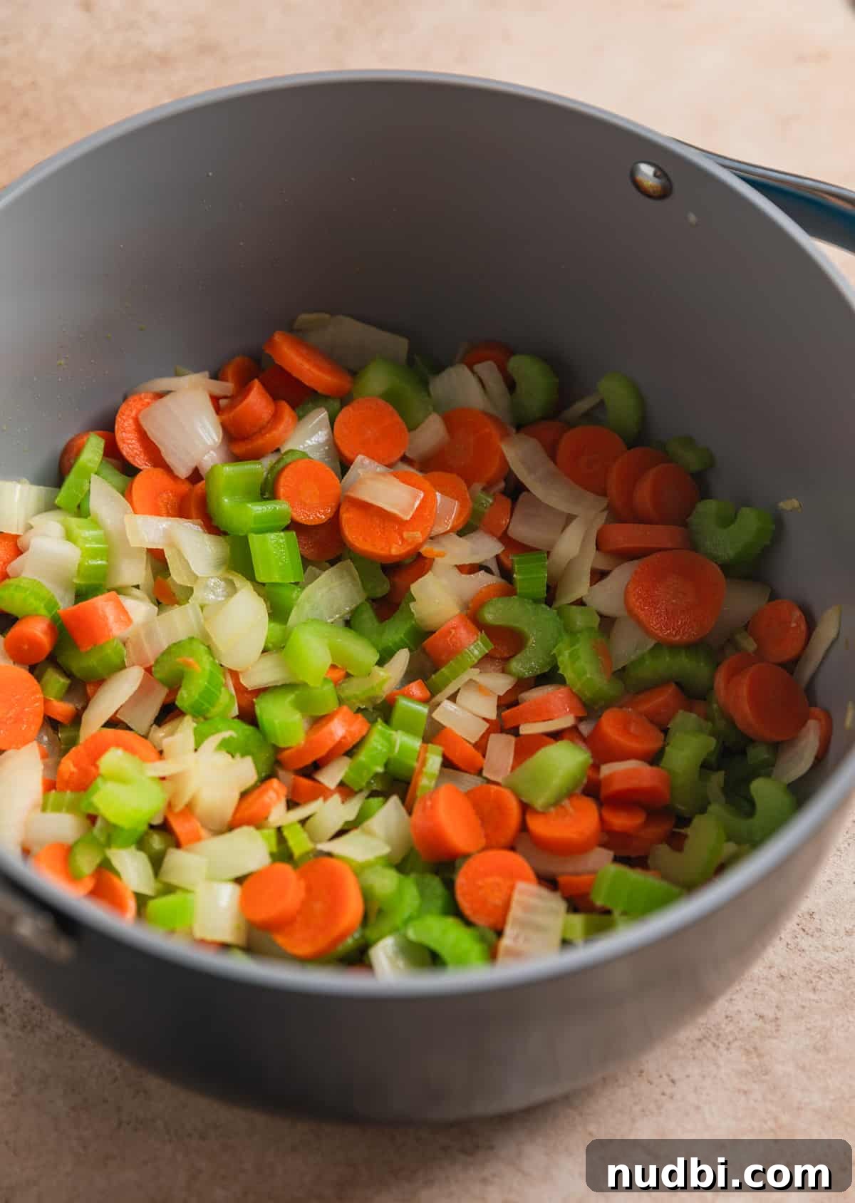 Lemony Chicken Orzo Soup Recipe for Comforting Weeknights 3 Celery, onion and carrots cooked in stock pot.