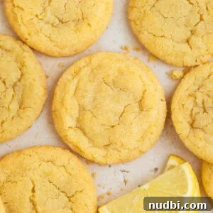 Most Popular Recipes of 2023: Trending Dishes You’ll Love 21 Lemon sugar cookies on surface with lemon wedges.