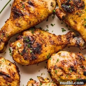 Most Popular Recipes of 2023: Trending Dishes You’ll Love 9 Overhead view of chicken legs grilled on white dish.