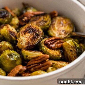 Maple Balsamic Roasted Brussels Sprouts Recipe 7 Dish with maple balsamic roasted brussels sprouts with pecans.