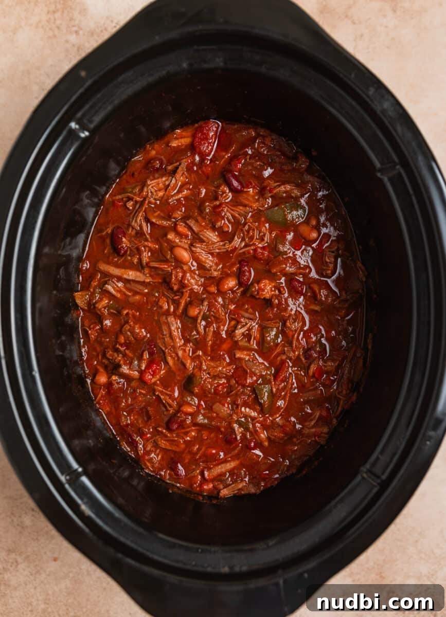 Slow Cooker Shredded Beef Chili Recipe for Comforting Weeknights 8 Shredded beef chili in crockpot after freshly shredded beef is added into the pot.