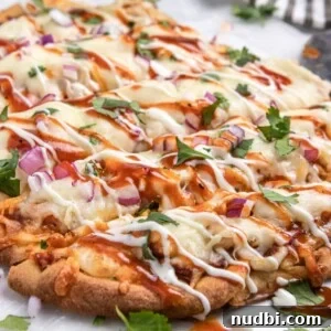 BBQ chicken flatbread with ranch and bbq sauce drizzle and fresh cilantro.
