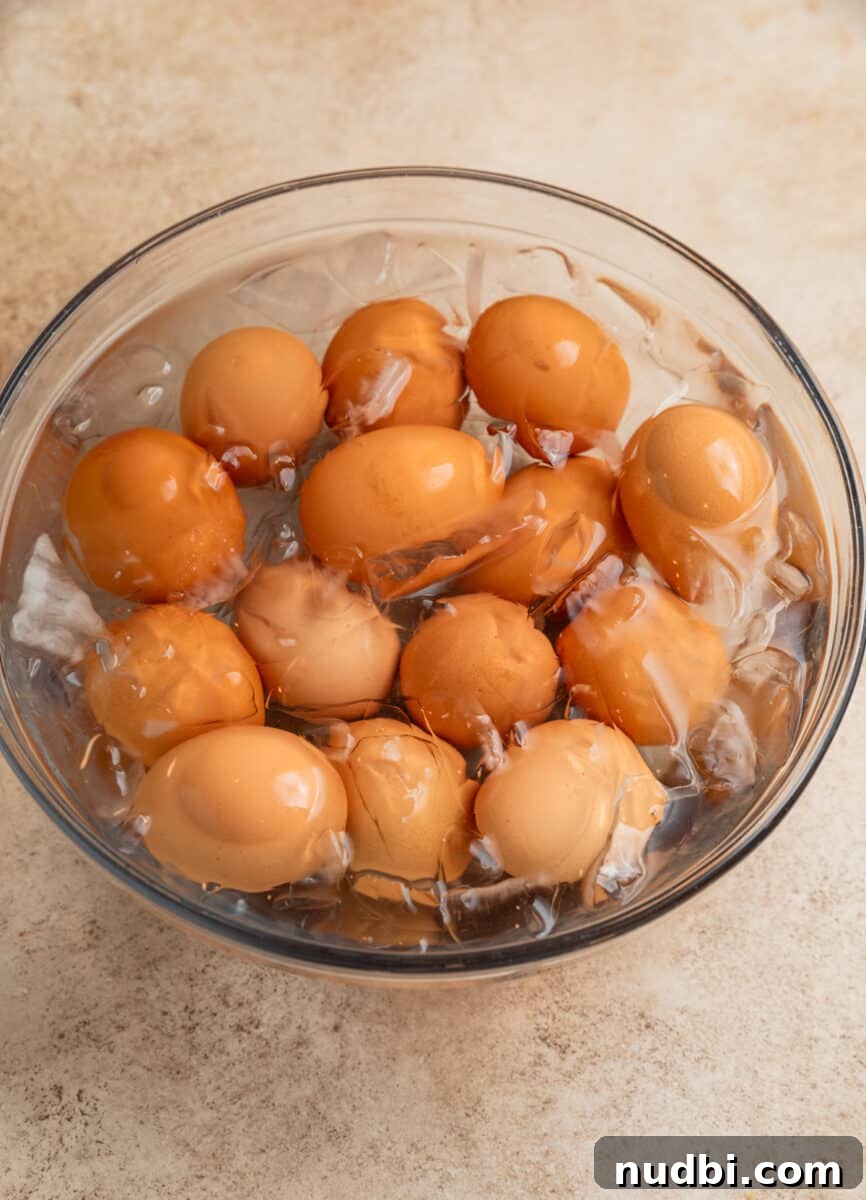 Spicy Deviled Eggs Recipe with Tangy Jalapeño Kick 5 Boiled eggs in ice bath after being hard boiled.