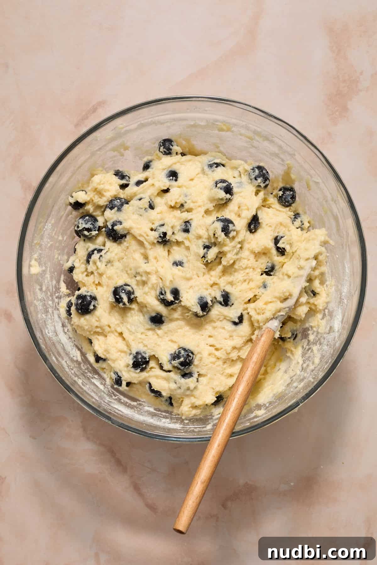 Blueberry Lemon Coffee Cake Recipe — Moist Citrus Bundt Cake 11 Blueberry lemon coffee cake batter in bowl with spatula.