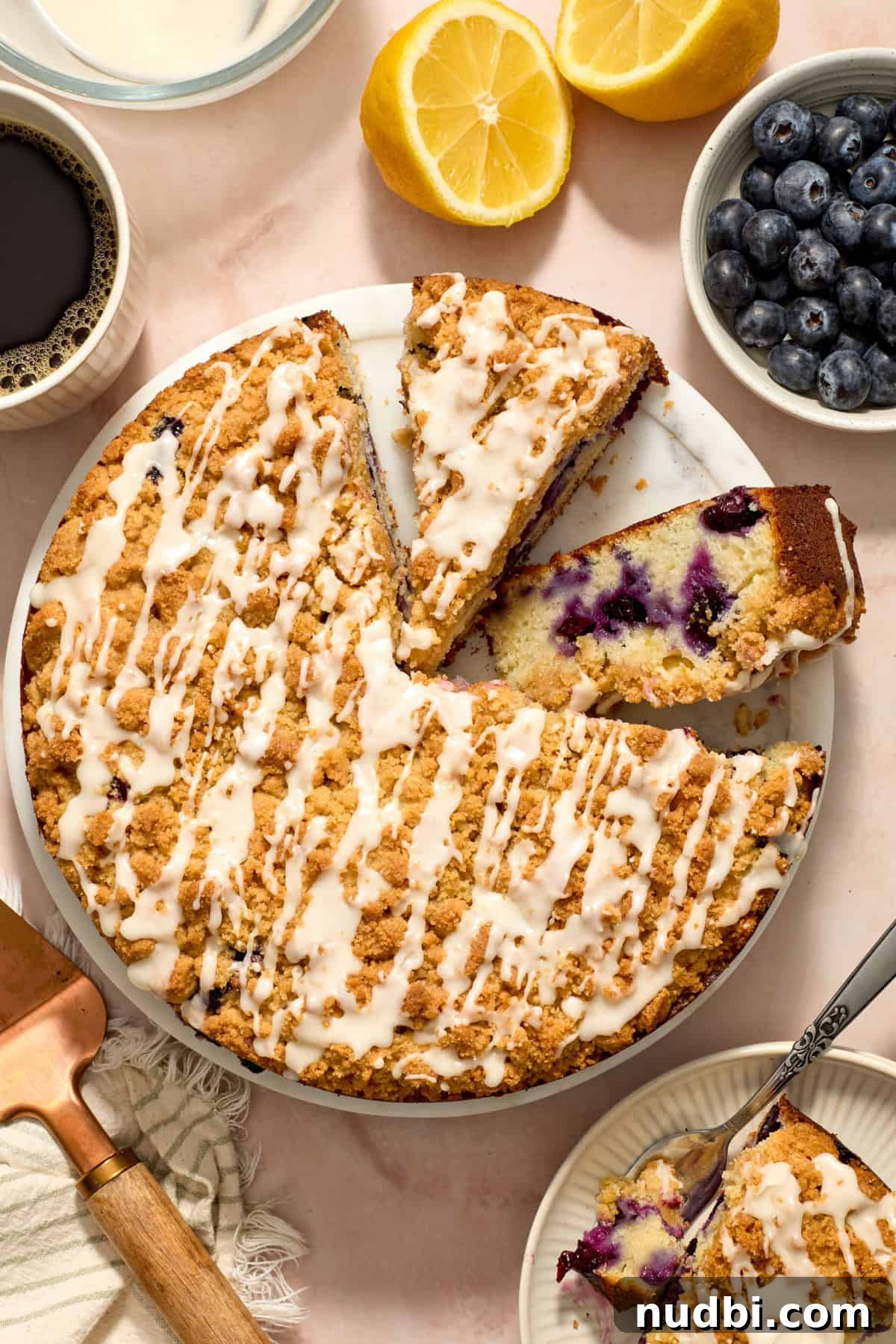 Blueberry Lemon Coffee Cake Recipe — Moist Citrus Bundt Cake 16 Overhead view of blueberry lemon coffee cake with one slice propped on its side.