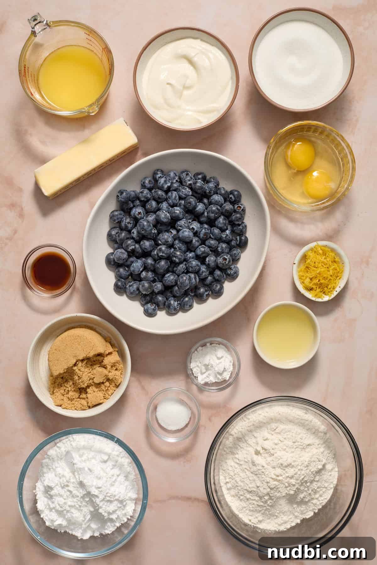 Blueberry Lemon Coffee Cake Recipe — Moist Citrus Bundt Cake 4 Ingredients needed to make recipe arranged on surface.