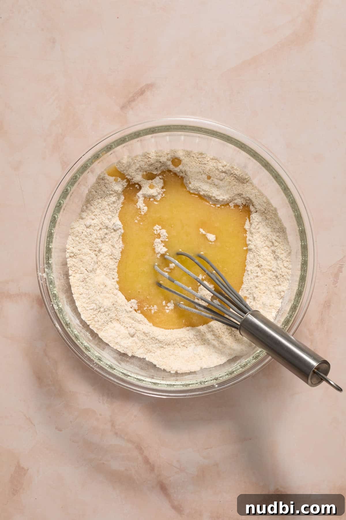 Blueberry Lemon Coffee Cake Recipe — Moist Citrus Bundt Cake 5 Melted butter added to dry ingredients in bowl.