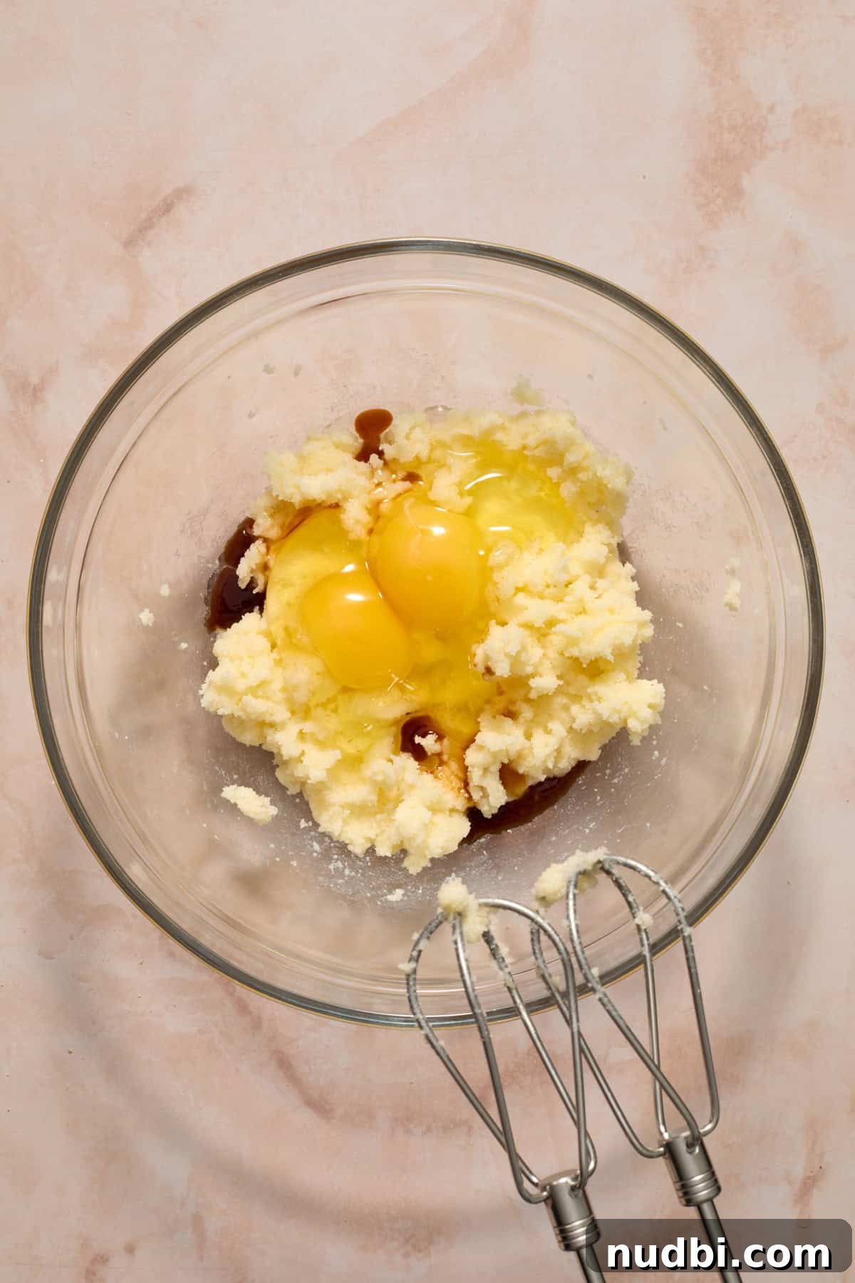 Blueberry Lemon Coffee Cake Recipe — Moist Citrus Bundt Cake 7 Creamed butter and sugar in bowl with eggs and vanilla added.