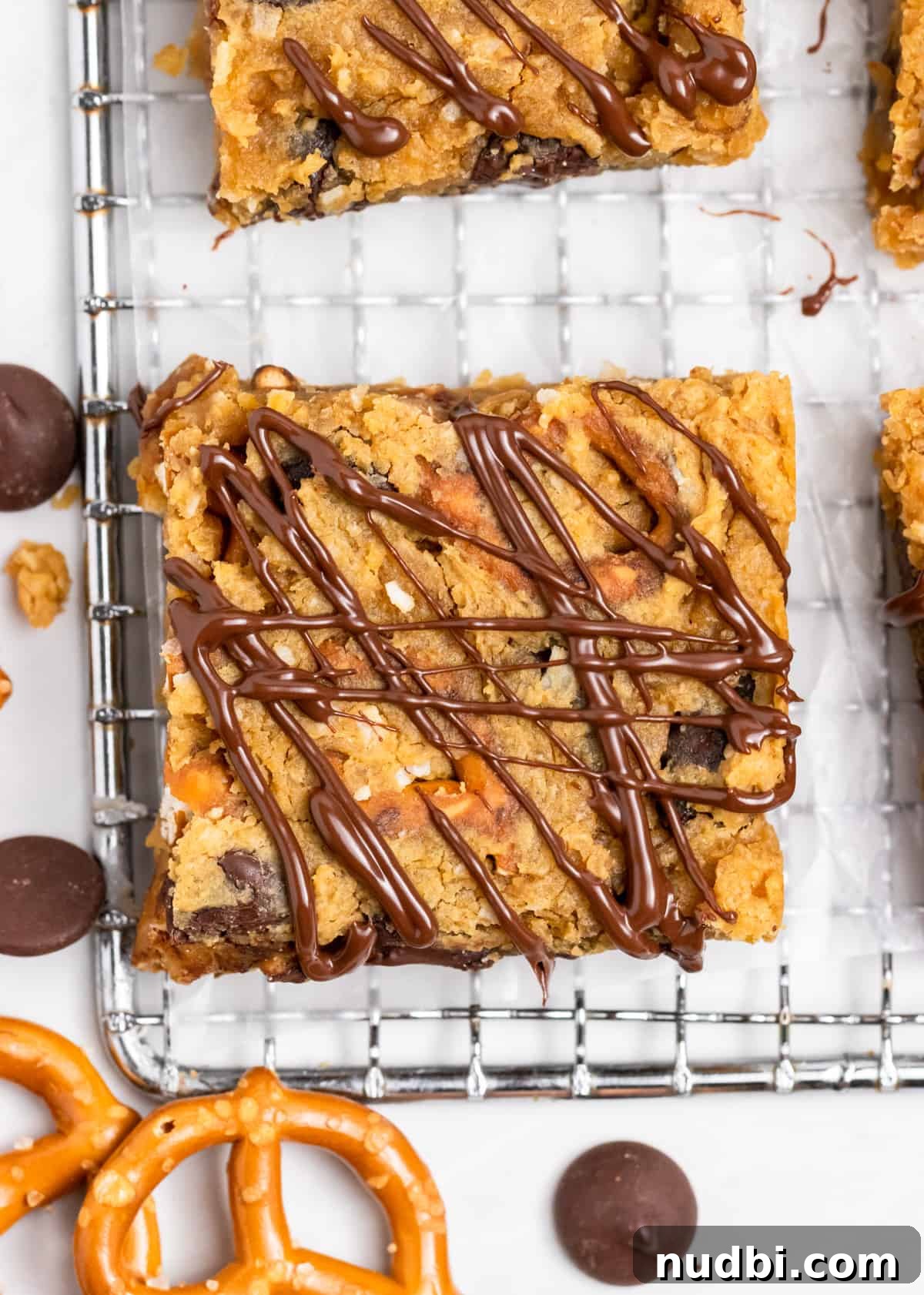 Peanut Butter Chickpea Blondies Recipe — High-Protein Treat 5 Chickpea blondies with drizzle on wax paper.