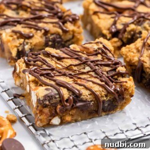 Peanut Butter Chickpea Blondies Recipe — High-Protein Treat 6 Chickpea blondies on cooling rack with chocolate drizzle.