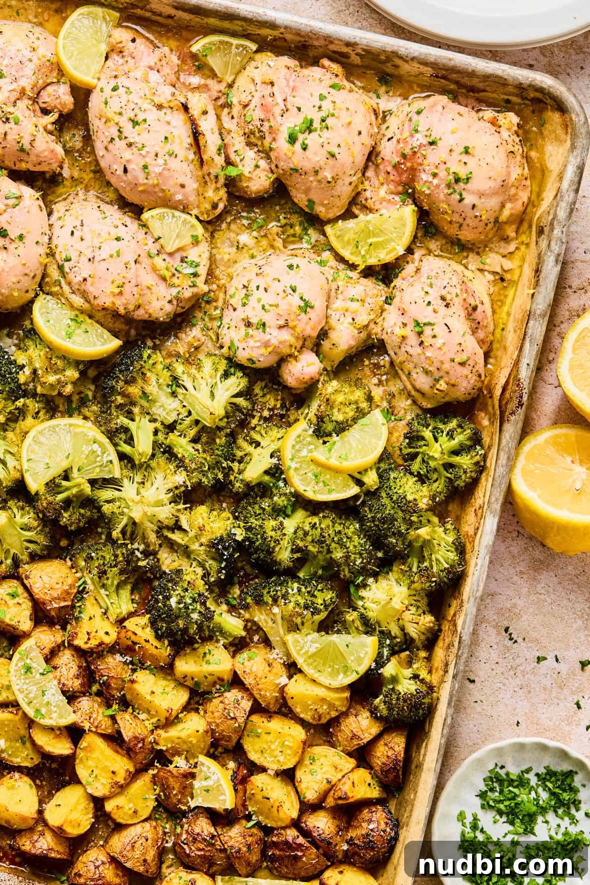 Crispy Lemon Chicken and Roasted Broccoli Sheet Pan Dinner 2 Lemon chicken sheet pan dinner on pan with broccoli and potatoes.