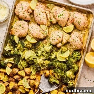 Crispy Lemon Chicken and Roasted Broccoli Sheet Pan Dinner 9 Lemon chicken sheet pan dinner on baking sheet with spatula.