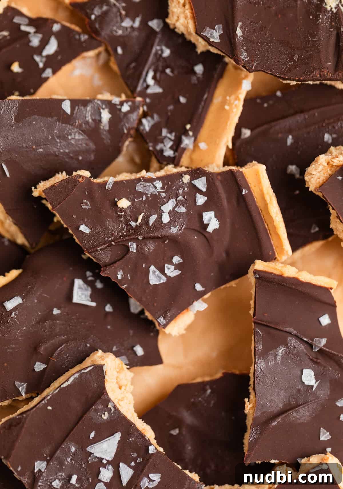 Creamy Greek Yogurt Bark Recipe with Fruit and Honey Toppings 2 Frozen peanut butter Greek yogurt bark covered in chocolate with sea salt flakes on top.