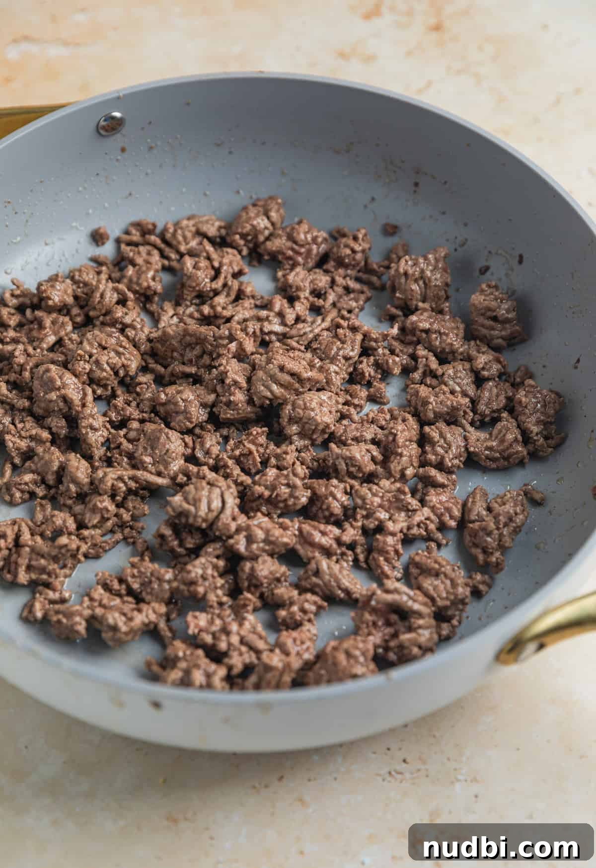 Ground beef browned in skillet.
