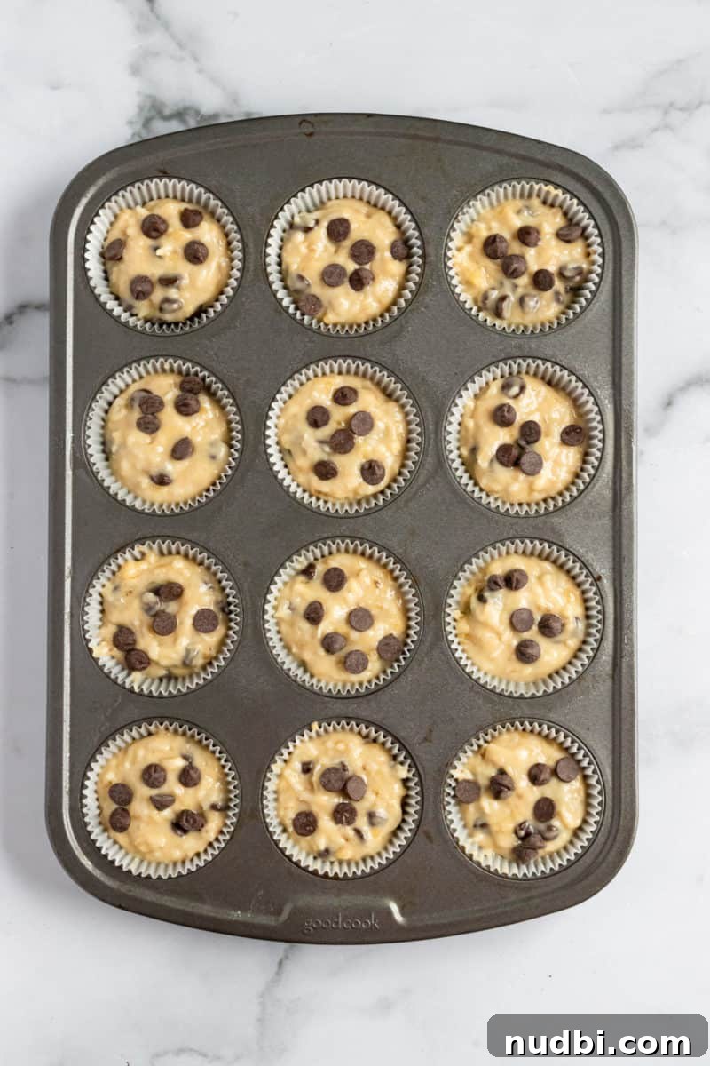 Coconut Banana Muffins with Chocolate Chips That Melt Inside 5 Coconut banana muffin batter in muffin tin before baking.
