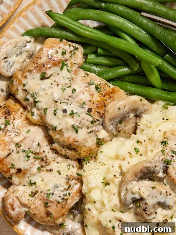 Creamy Skillet Lemon Chicken Recipe for Quick Weeknight Meals 12 Plate with creamy chicken thighs and mushrooms with mashed potatoes and green beans.