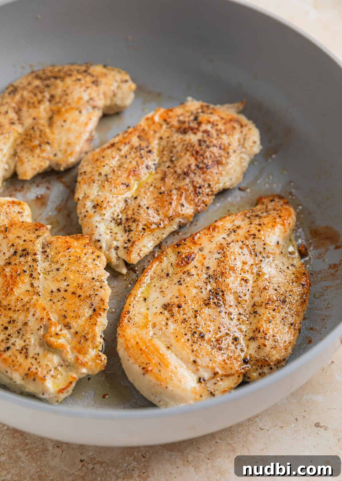 Creamy Skillet Lemon Chicken Recipe for Quick Weeknight Meals 4 Seared chicken breast in skillet.