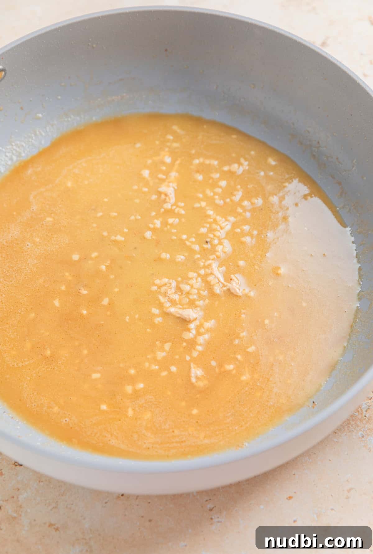 Creamy Skillet Lemon Chicken Recipe for Quick Weeknight Meals 5 Butter, garlic and broth melted in skillet.