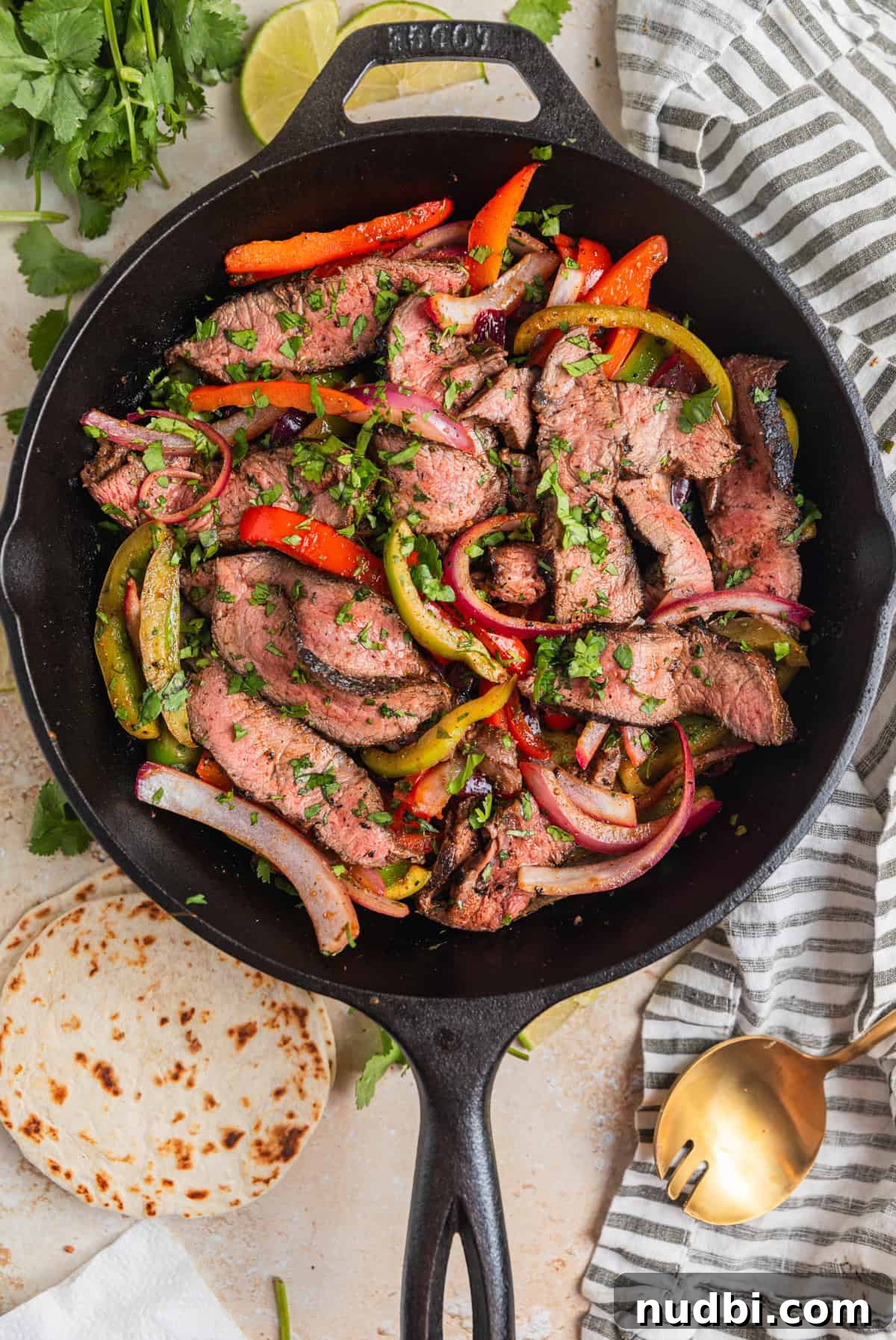 Cilantro-Lime Flat Iron Steak Fajitas Recipe 10 Skillet with flat iron steak slices and fajita vegetables topped with cilantro.