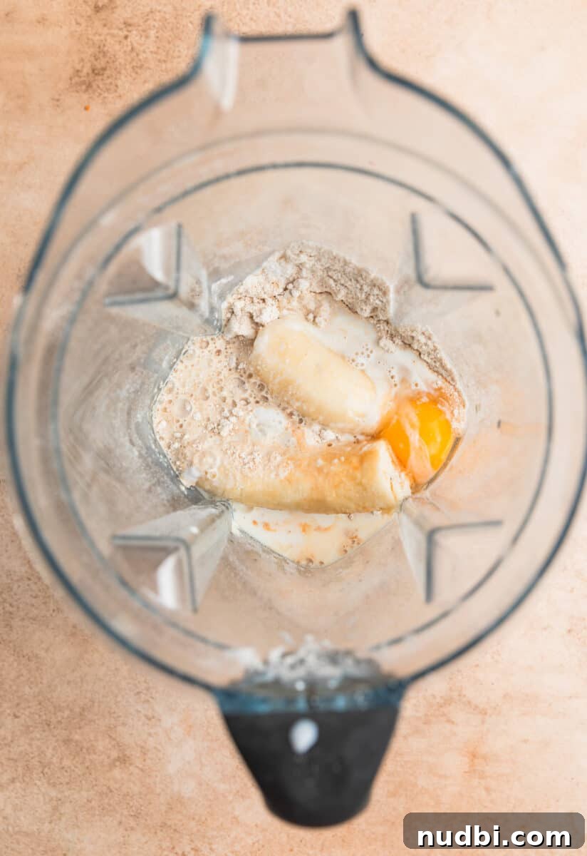 Fluffy Banana Oat Blender Pancakes in Minutes 6 Banana, egg, vanilla and other ingredients in blender before being blended.
